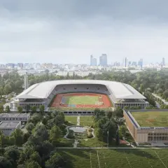 Nowoczesny stadion lekkoatletyczny z bieżnią i boiskiem, otoczony zielenią, w tle panorama miasta. To przyszłość Agrykoli.