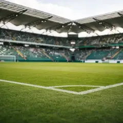 Piłkarskie boisko ze stadionem w tle, gotowe na decydujący mecz barażowy.
