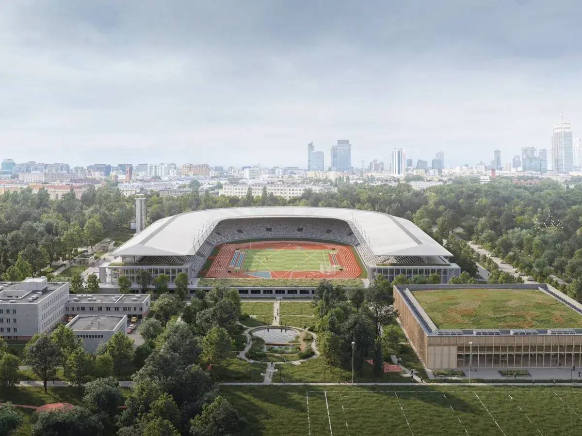 Nowoczesny stadion lekkoatletyczny z bieżnią i boiskiem, otoczony zielenią, w tle panorama miasta. To przyszłość Agrykoli.