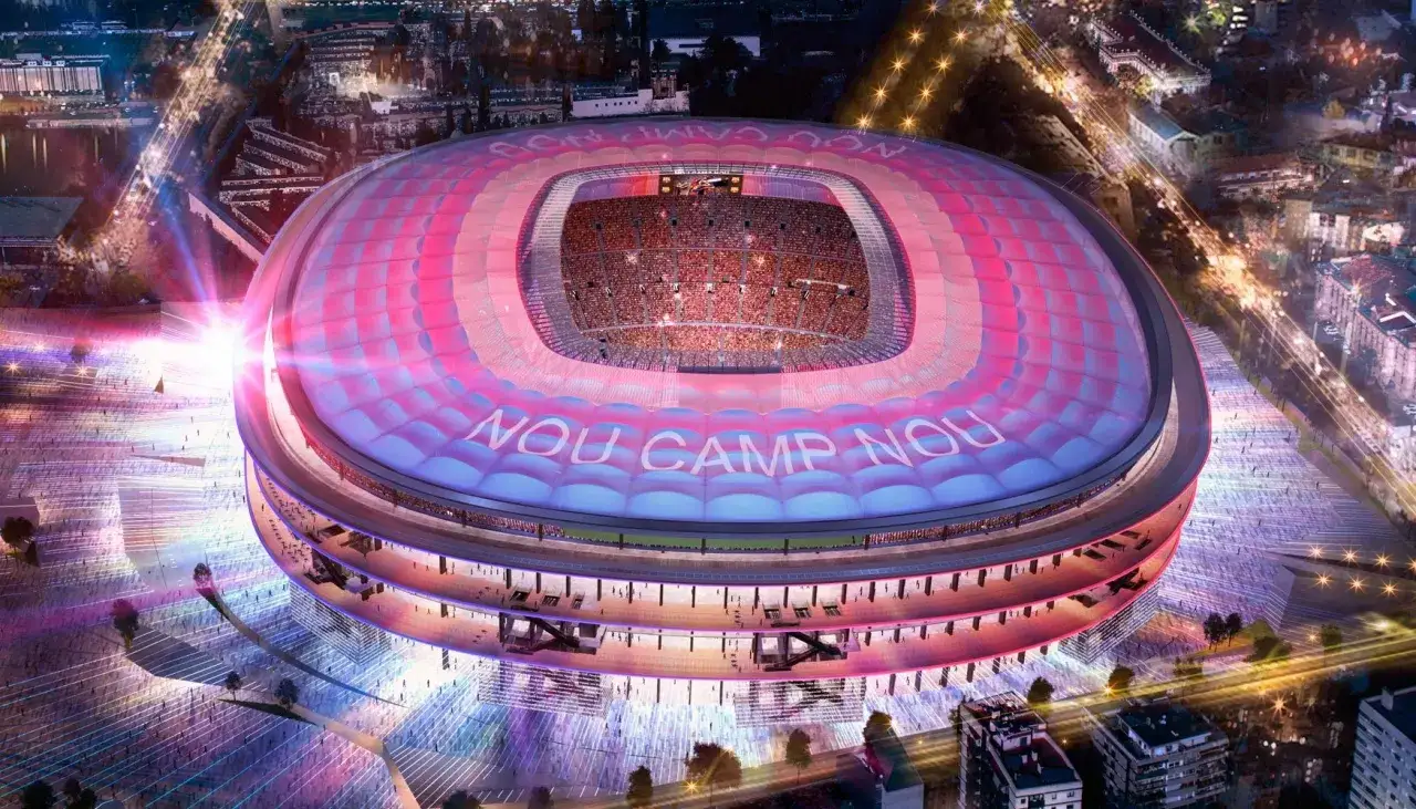 Nocny widok na nowoczesny stadion, gdzie na dachu widnieje napis 
