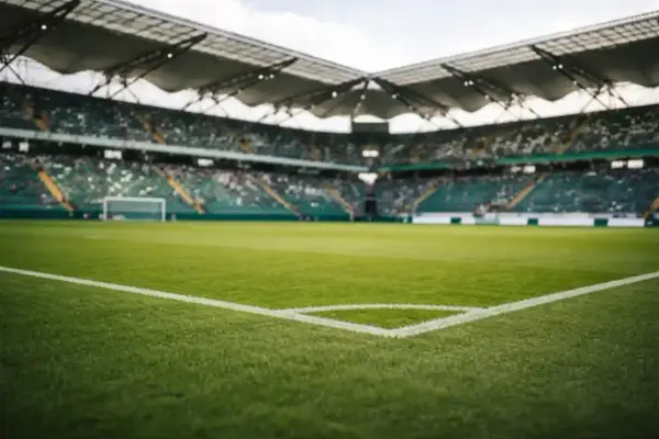 Piłkarskie boisko ze stadionem w tle, gotowe na decydujący mecz barażowy.